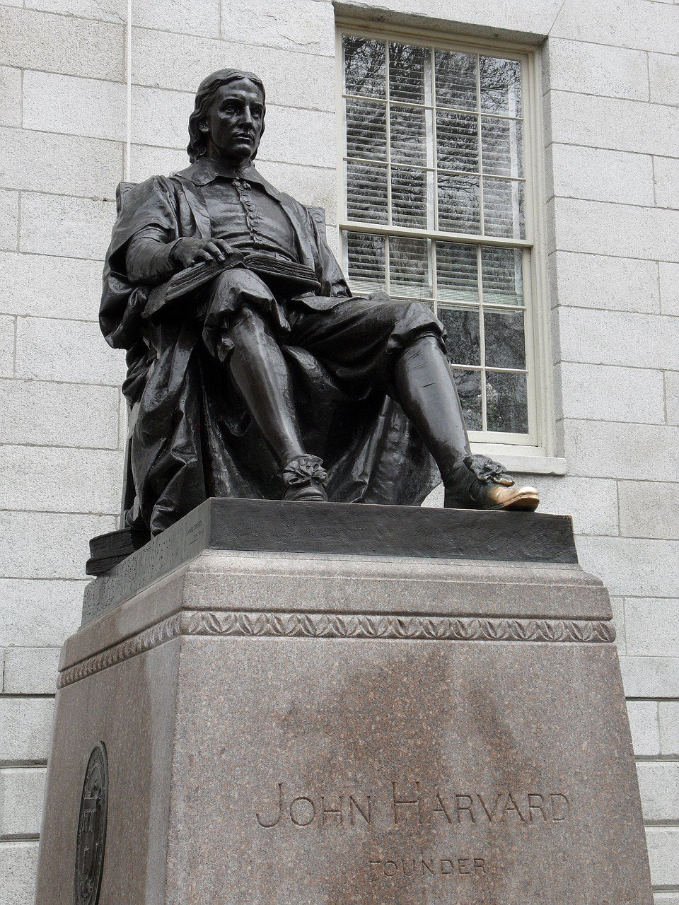 Statue of John Harvard in the university campus named after him