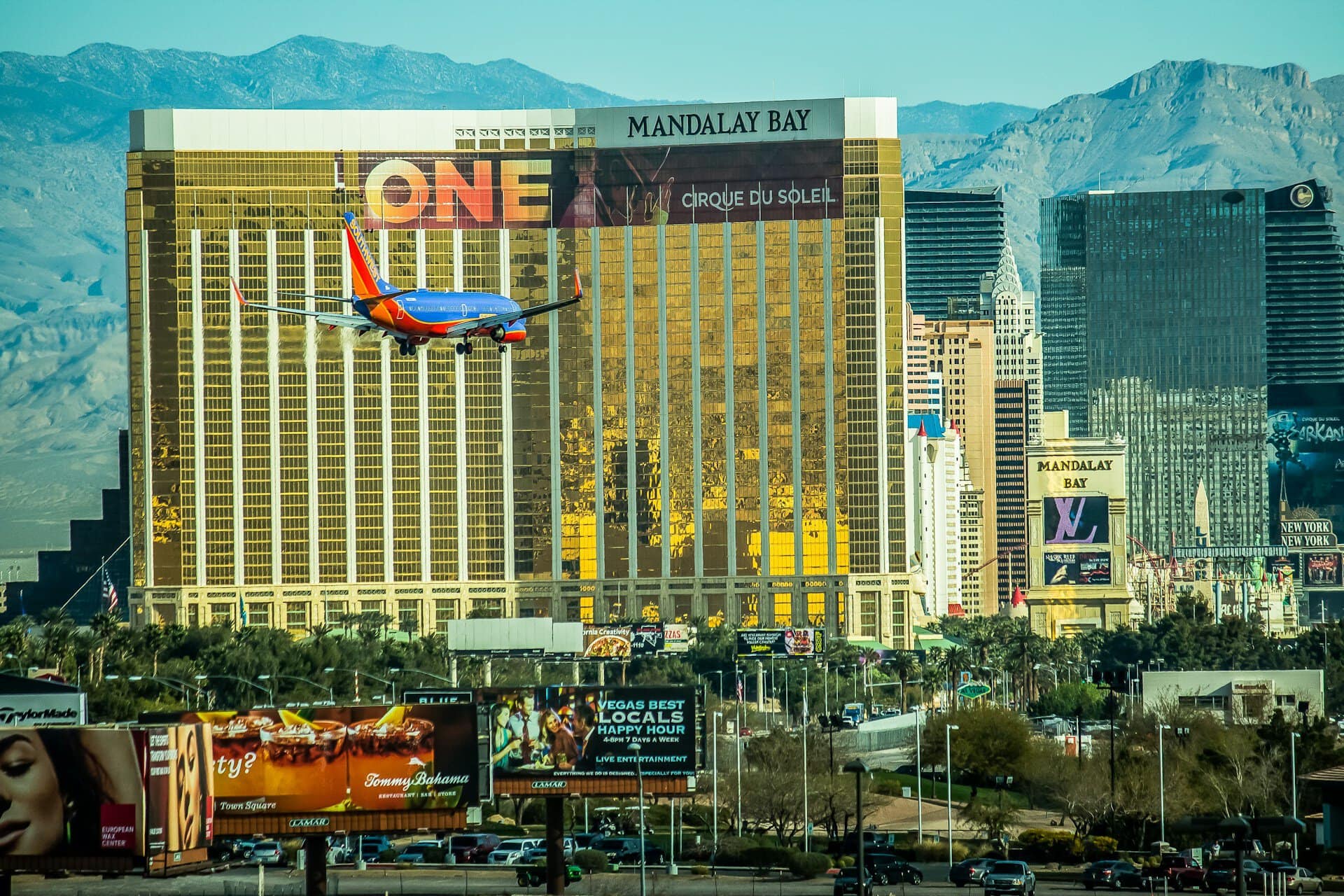 A plane landing with Mandalay Bay Hotel and Casino in the background in Las Vegas
